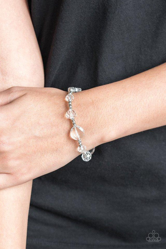 Paparazzi Starry-Eyed Elegance - White  -  A collection of glittery white beads and shiny silver beads are threaded along a stretchy band around the wrist for a refined look.
