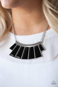 Paparazzi Glamour Goddess - Black Faceted black emerald style beads are pressed into a hammered silver plate. Featuring flared bottoms, the bold beads fan out below the collar for a fierce finish. Features an adjustable clasp closure.

