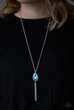 Paparazzi Elite Shine - Blue  -  A blue teardrop gem swings from the bottom of a lengthened silver chain for a dramatic look. A shimmery silver chain tassel swings from the bottom of the pendant for a glamorous finish. Features an adjustable clasp closure.
