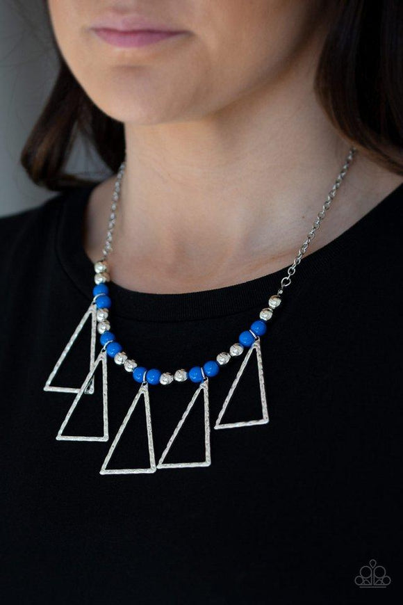 Paparazzi Terra Nouveau - Blue  -  A collection of shiny silver and refreshing blue beads are threaded along an invisible wire below the collar. Hammered triangular frames swing from the bottom of the colorful compilation, creating an artistic fringe. Features an adjustable clasp closure.
