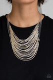 Paparazzi Catwalk Queen - Multi Strand after strand of metallic gold and silver seed beads fall together to create a bold statement piece. Features an adjustable clasp closure.
