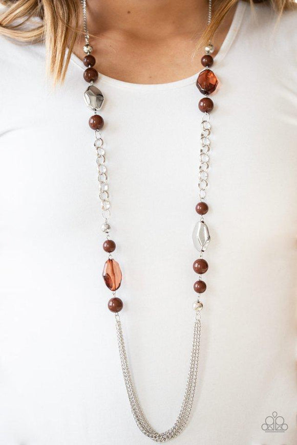 Paparazzi Marina Majesty - Brown A collection of faceted silver, crystal-like brown, polished brown, and silver beads give way to layers of shimmery silver chains for a whimsical look. Features an adjustable clasp closure.

