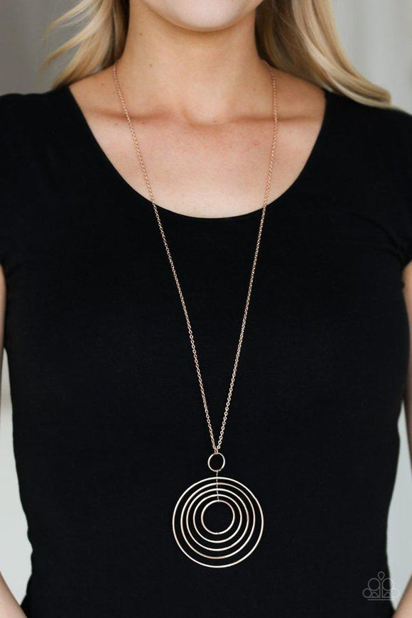 Paparazzi Running Circles In My Mind - Rose Gold  -  Threaded through a rose gold fitting, a collection of rose gold hoops collect into a dizzy pendant at the bottom of a lengthened rose gold chain for a refined look. Features an adjustable clasp closure.

