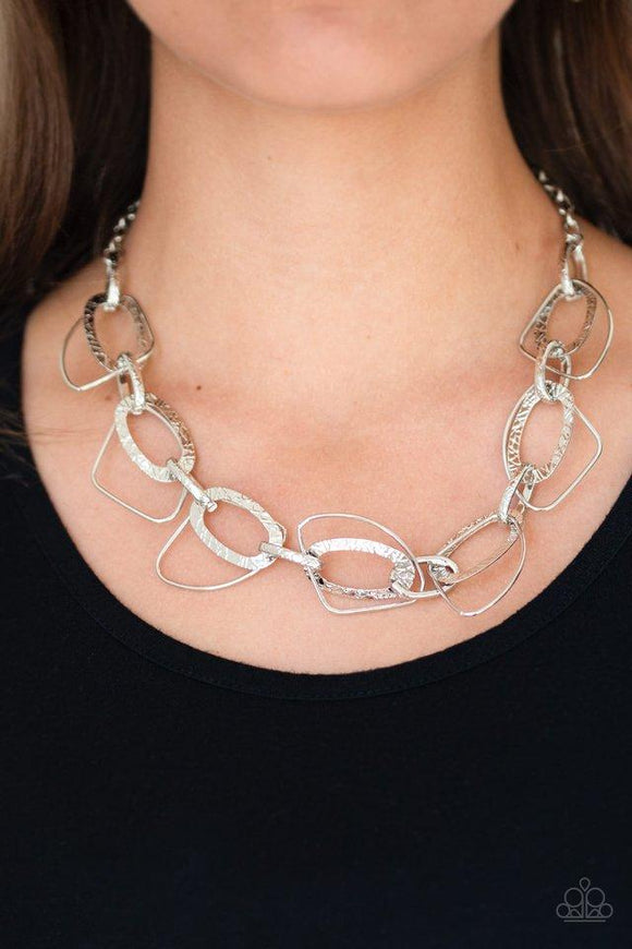 Paparazzi Very AvantGarde- Silver Embossed in glistening patterns, a collection of textured silver hoops connect with asymmetrical silver frames below the collar for an edgy industrial look. Features an adjustable clasp closure.

