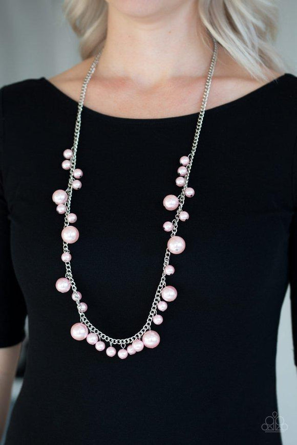 Paparazzi There's Always Room At The Top- Pink Varying in size, bubbly pink pearls trickle along a shimmery silver chain for a refined look. Features an adjustable clasp closure.

