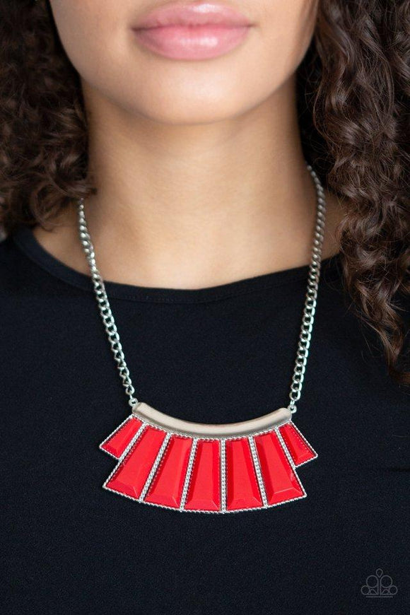 Paparazzi Glamour Goddess - Red Featuring the dramatic red hue of Chili Pepper, faceted emerald style beads are pressed into a hammered silver plate. Featuring flared bottoms, the colorful beads fan out below the collar for a fierce finish. Features an adjustable clasp closure.

