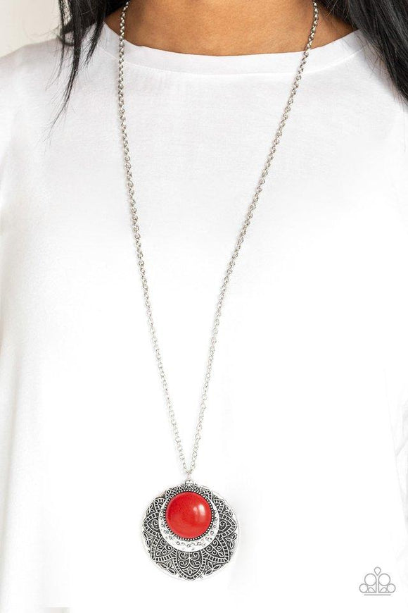 Paparazzi Medallion Meadow - Red Swinging from the bottom of a lengthened silver chain, a fiery red stone is pressed into a hammered silver medallion radiating with floral details for a bold tribal inspired look. Features an adjustable clasp closure.

