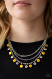 Paparazzi Beach Flavor - Yellow  -  Mismatched silver chains layer below the collar. Shell-like yellow beads and shiny silver beads trickle from the lowermost chain, creating an iridescent fringe. Features an adjustable clasp closure.
