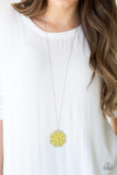 Paparazzi Spin Your PINWHEELS - Yellow Brushed in a sunny yellow hue, filigree filled petals spin around a silver beaded center for a colorful look. The frilly floral pendant swings from the bottom of a lengthened silver chain for a whimsical finish. Features an adjustable clasp closure.

