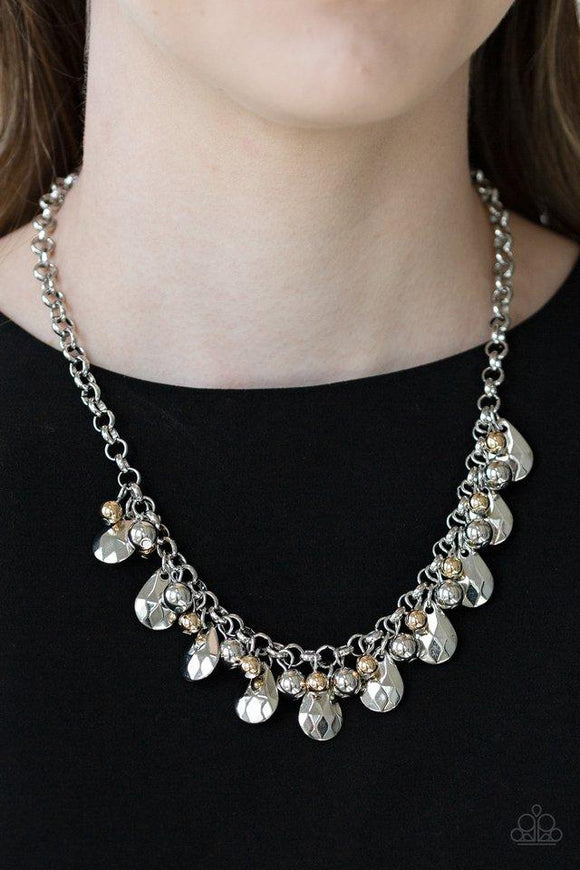 Paparazzi Stage Stunner - Silver A collection of shiny silver and glistening gold beads join faceted silver teardrops along the bottom of a bold silver chain, creating an edgy fringe below the collar. Features an adjustable clasp closure.

