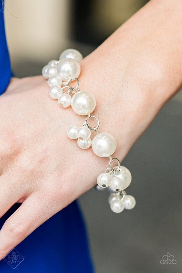 Paparazzi Broadway Ballroom - White Infused with clusters of dainty white pearls, oversized pearls link around the wrist, creating a bubbly fringe. Features an adjustable clasp closure.

