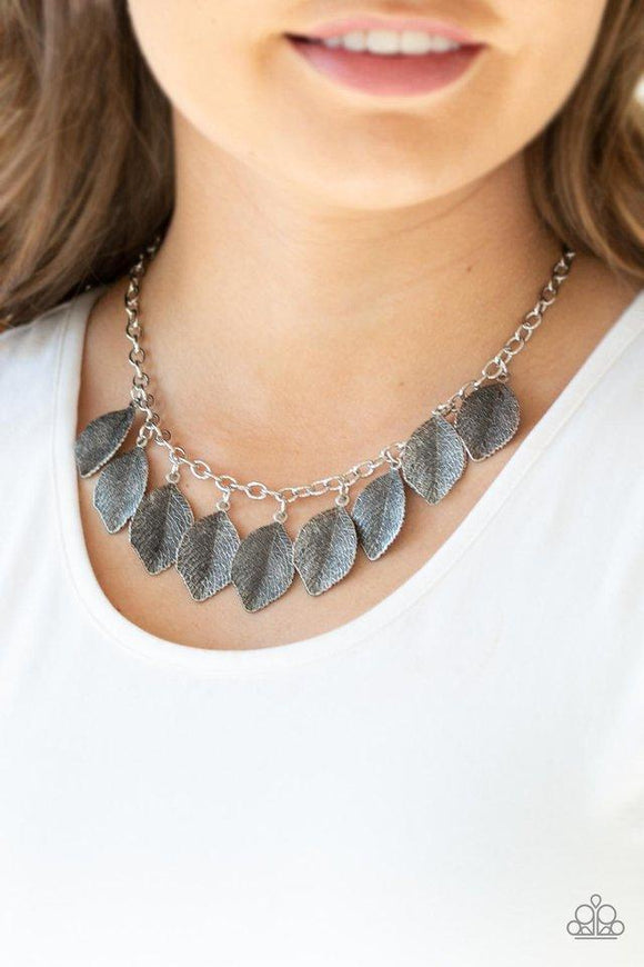 Paparazzi A True Be-LEAF-er - Silver Embossed in lifelike textures, antiqued silver leaves swing from the bottom of a glistening silver chain, creating a seasonal fringe below the collar. Features an adjustable clasp closure.
