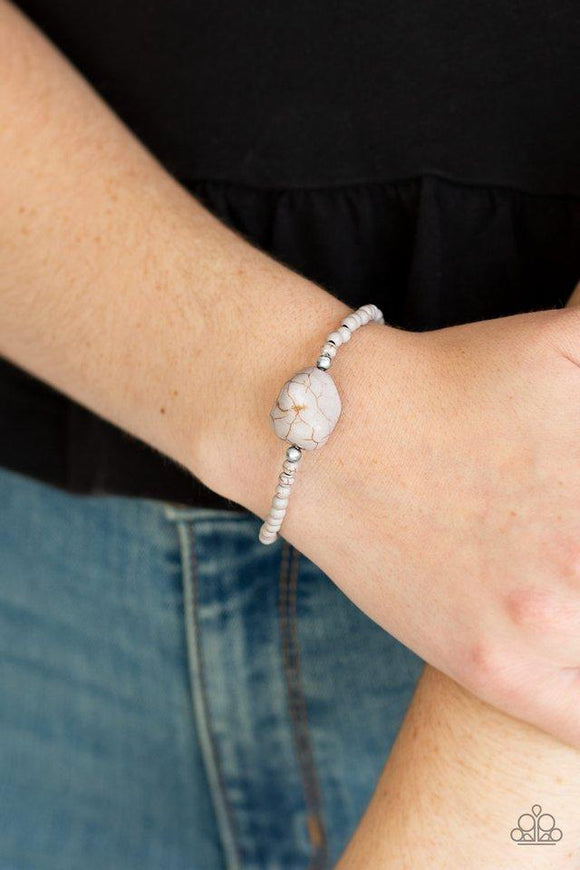 Paparazzi Eco Eccentricity - Silver Infused with dainty silver beads and earthy gray stone beads, a large gray pebble is threaded along a stretchy band around the wrist for a seasonal flair.

