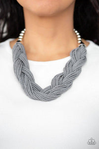Paparazzi The Great Outback - Silver  -  Brushed in a neutral gray hue, countless seed beads weave into an indigenous braid below the collar. The colorful strands attach to large silver beads, adding a hint of metallic shimmer to the playful design. Features an adjustable clasp closure.
