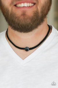 Paparazzi Go Climb A Mountain - Blue  -  Flanked by dainty black beads, a glassy blue bead is knotted in place along a black braided cord for a seasonal look. Features a button loop closure.
