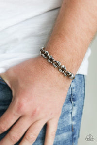 Paparazzi Ride The Rails - Brown - Set  -  Shiny brown cording weaves through hammered silver beads around the wrist for an urban look. Features an adjustable sliding knot closure.
