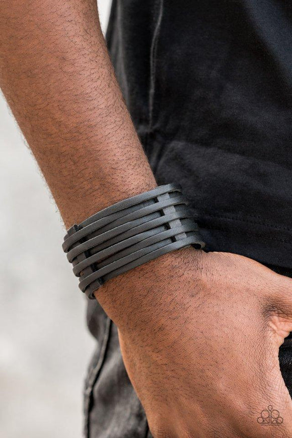 Paparazzi The Starting Lineup - Black - 2019 Convention Exclusive
A thick black leather band has been spliced into skinny strands that interweave through leather belt loops across the wrist for a rugged look. Features an adjustable snap closure.
