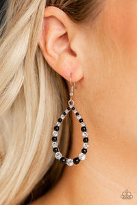 Paparazzi Gala Go-Getter - Black A collection of shiny black beads and glassy white rhinestones are encrusted along an airy silver teardrop for a timeless look. Earring attaches to a standard fishhook fitting.
