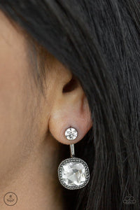 Paparazzi Celebrity Cache - Black - Earrings  -  A solitaire white rhinestone attaches to a double-sided post, designed to fasten behind the ear. Featuring a faceted white gem, the glitzy double-sided post peeks out beneath the ear for a refined look. Earring attaches to a standard post fitting.
