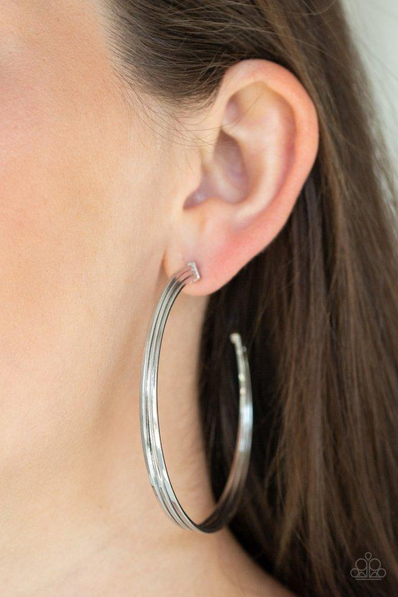 Paparazzi Wheelhouse - Silver  -  Three flat silver bars curl around the ear, boldly stacking into an edgy hoop. Hoop measures approximately 2 1/2