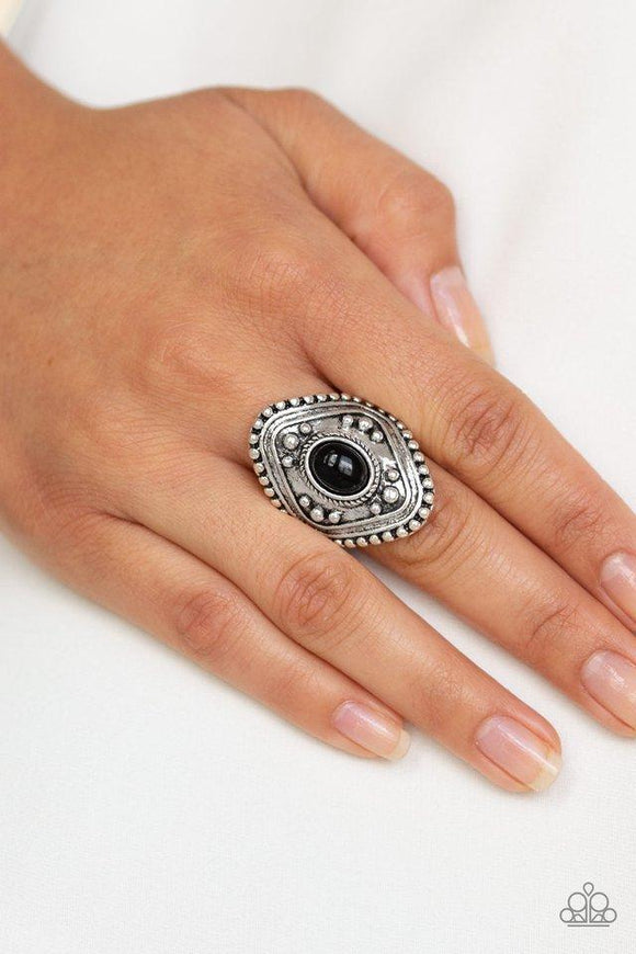 Paparazzi Rogue Ramble - Black A shiny black bead is pressed into the center of a thick silver frame radiating with studded texture for a bold tribal look. Features a stretchy band for a flexible fit.

