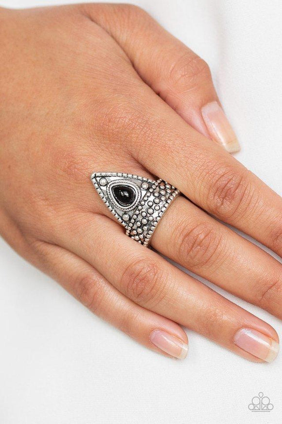 Paparazzi Tropical Escapade - Black A shiny black bead is pressed into the center of a triangular frame atop a studded silver band for a seasonal flair. Features a dainty stretchy band for a flexible fit.

