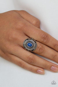 Paparazzi Oasis Moon - Blue A shiny blue bead is pressed into the center of a round frame radiating with silver studded detail for a seasonal look. Features a dainty stretchy band for a flexible fit.

