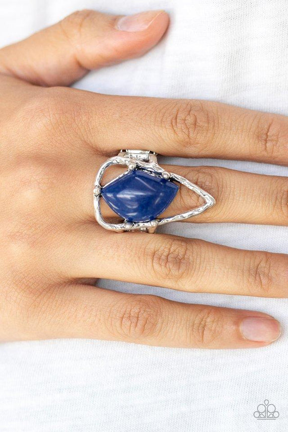Paparazzi Get The Point - Blue An abstract blue stone is nestled inside a hammered silver triangle, creating an artisan inspired frame atop the finger. Features a stretchy band for a flexible fit.
