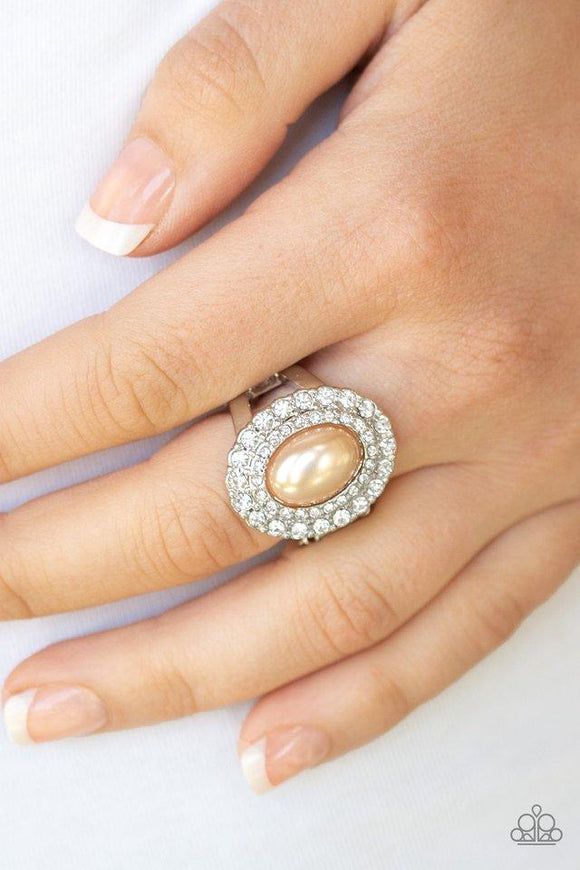 Paparazzi Sprinkle On The Shimmer - Brown  -  Two rings of glassy white rhinestones spin around a pearly brown center for a refined flair. Features a stretchy band for a flexible fit.
