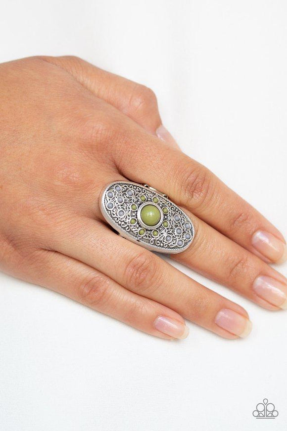 Paparazzi Solar Plexus - Green Brushed in an antiqued finish, vine-like filigree climbs an oval silver frame. Sprinkled with dainty green and gray beads, the whimsical frame is dotted with a bold green beaded center for a colorful finish. Features a stretchy band for a flexible fit.
