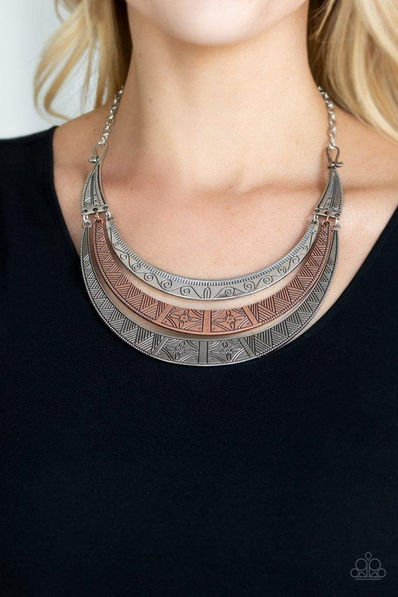 Paparazzi Take All You Can GATHERER - Multi Stamped in an array of floral and tribal inspired patterns, a collection of silver and copper half-moon plates layer below the collar for a fierce look. Features an adjustable clasp closure.


