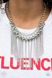 Paparazzi Powerhouse Prowl- Silver A collection of brightly polished silver beads dances along the collarbone as they swing from a chunky silver chain. Streams of silver chain cascade in between the metallic spheres, creating an edgy industrial fringe. Features an adjustable clasp closure.

