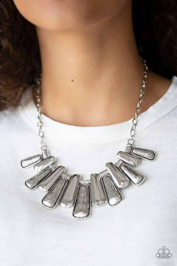 Paparazzi Mane Up - Silver Featuring smooth and etched finishes, a collection of glistening silver plates link below the collar, creating a blinding fringe. Features an adjustable clasp closure.
