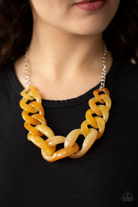 Paparazzi Red-HAUTE Mama - Yellow Featuring a faux marble finish, yellow acrylic links gradually increase in size as they link below the collar in a statement-making fashion. Features an adjustable clasp closure.
