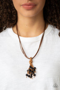 Paparazzi Tassel Trek - Black A black beaded tassel knots around strands of shiny brown cording below the collar for a seasonal look. Features an adjustable sliding knot closure.
