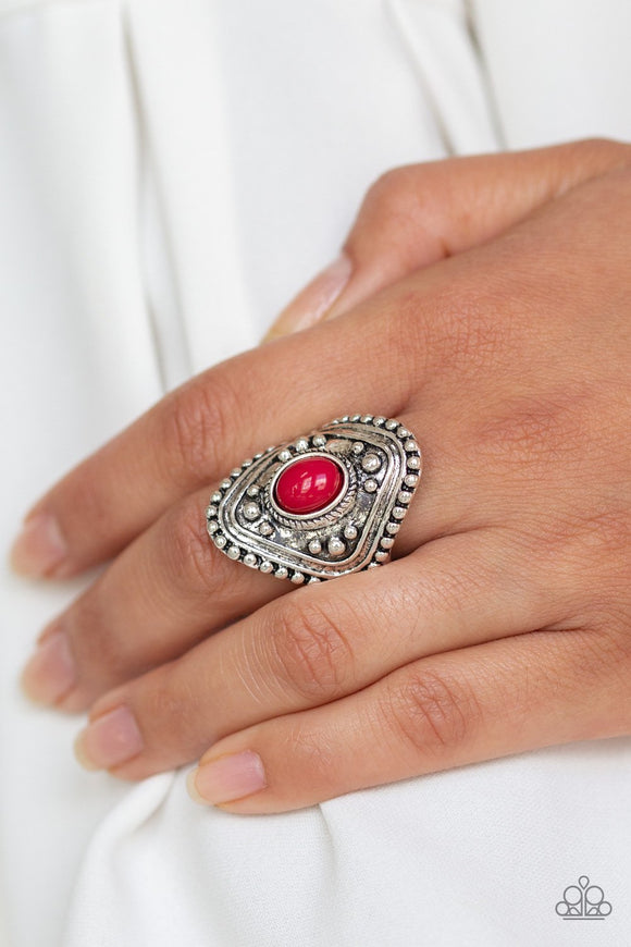 Paparazzi Rogue Ramble - Red A robust red bead is pressed into the center of a thick silver frame radiating with studded texture for a bold tribal look. Features a stretchy band for a flexible fit.
