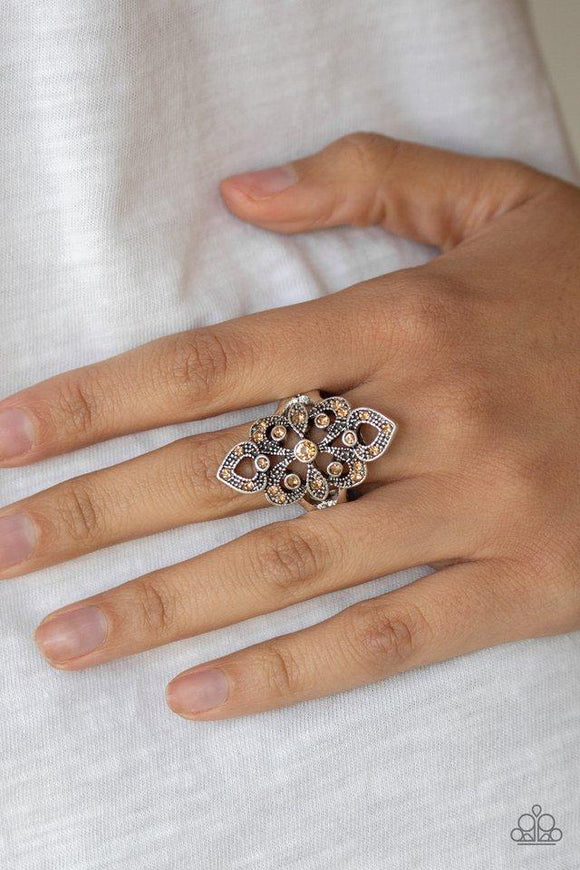 Paparazzi Princess Priss - Brown Dainty topaz rhinestones are sprinkled along an ornate silver frame swirling with studded filigree for a refined flair. Features a dainty stretchy band for a flexible fit.
