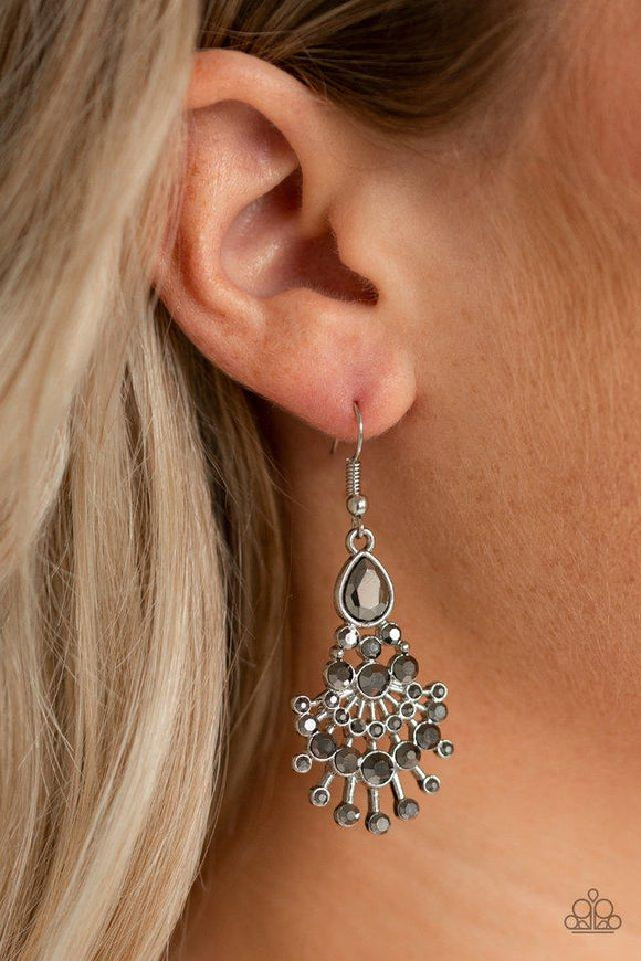 Paparazzi Wheres The Limo? - Silver A cascade of hematite teardrop and round rhinestones coalesce into a glittery chandelier-like frame for a glamorous fashion. Earring attaches to a standard fishhook fitting.
