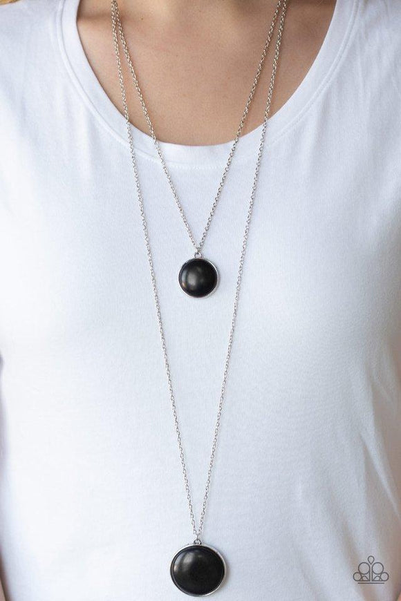 Paparazzi Desert Medallions - Black A smooth black stone pendant is suspended above a slightly larger white stone pendant, creating earthy layers down the chest. Features an adjustable clasp closure.
