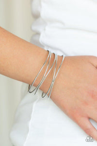 Paparazzi Showstopping Sheen - Silver A collection of glistening silver bangles join into an abstractly layered cuff around the wrist for a casual glam.
