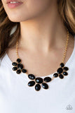 Paparazzi Flair Affair - Black  -  Gradually increasing in size near the center, a collection of black beaded gold frames link into a gorgeous statement piece. Featuring a faceted finish, the sparkling oval beaded frames fan out below the collar for a refined flair. Features an adjustable clasp closure.
