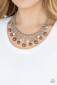 Paparazzi HEIR-headed - Brown A collection of bubbly brown pearls, glittery white rhinestones, and ornate silver beads swing from the bottom of a shimmery silver chain, creating a refined fringe below the collar. Features an adjustable clasp closure.
