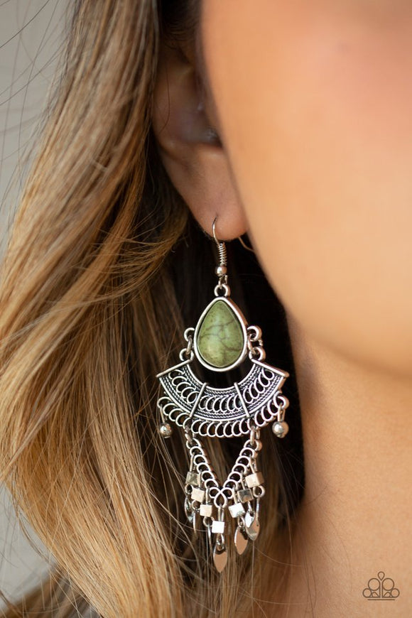 Paparazzi Vintage Vagabond - Green - Earrings  -  An earthy green teardrop stone gives way to a stack of linked silver frames featuring bold tribal inspired patterns. Infused with glistening silver cube beads, a fringe of flat silver beads swing from the bottom for a flirtatiously wanderlust finish. Earring attaches to a standard fishhook fitting.
