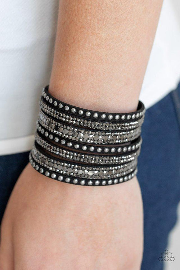 Paparazzi All Hustle and Hairspray - Black  -  A thick black suede band has been spliced into glittery strands encrusted in a collection of dainty gunmetal studs, glittery hematite rhinestones, and flat gunmetal sequins for a sassy look. Features an adjustable snap closure.
