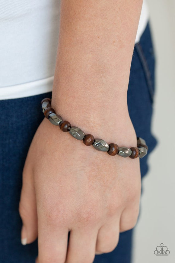 Paparazzi Resilient - Brown - Bracelet  -  An earthy collection of faceted gunmetal beads and smooth wooden beads are threaded along a stretchy band around the wrist for a bold seasonal look.
