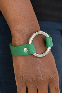 Paparazzi Rustic Rodeo - Green Infused with pieces of refreshing green leather, an oversized silver ring is studded in place atop the center of the wrist for a rustic flair. Features an adjustable snap closure.
