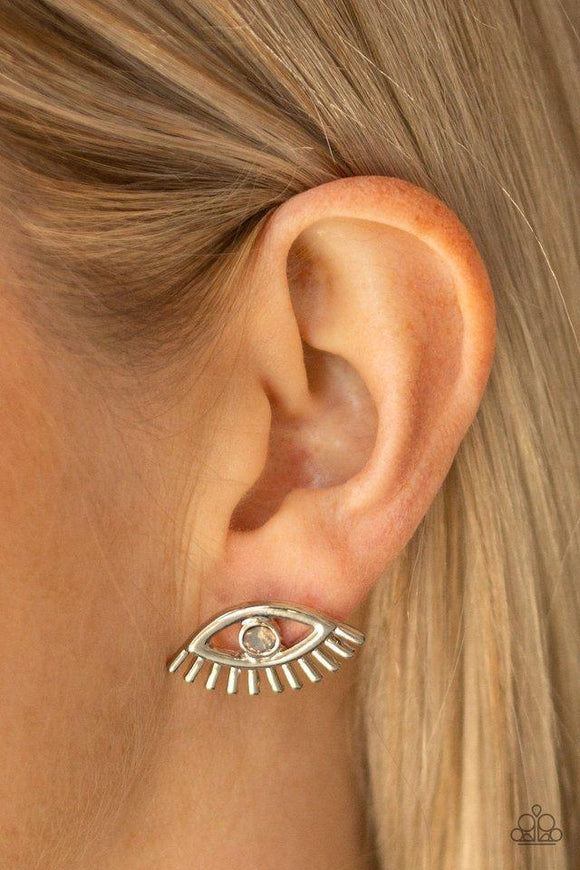 Paparazzi Dont Blink - Multi  -  A dainty opalescent rhinestone is pressed into the center of a silver eye-shaped frame for a funky fashion. Earring attaches to a standard post fitting.
