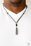 Paparazzi Midnight Meteorite - Black  -  Infused with shiny silver beads, a chunk of hematite swings from the bottom of a lengthened strand of black leather cording, creating an urban pendant. Features an adjustable sliding knot closure. Size may vary.
