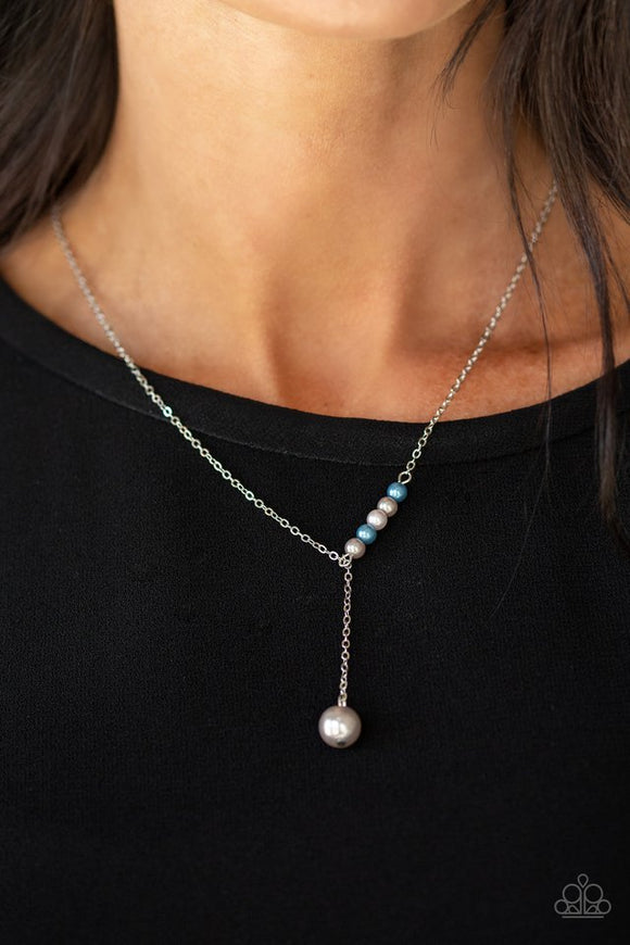 Paparazzi Timeless Taste - Multi - Necklace  -  A solitaire silver pearl swings from the bottom of a glistening silver chain, creating a timeless extended pendant below the collar. A section of dainty silver and blue pearls dot one side of the chain for a refined asymmetrical finish. Features an adjustable clasp closure.
