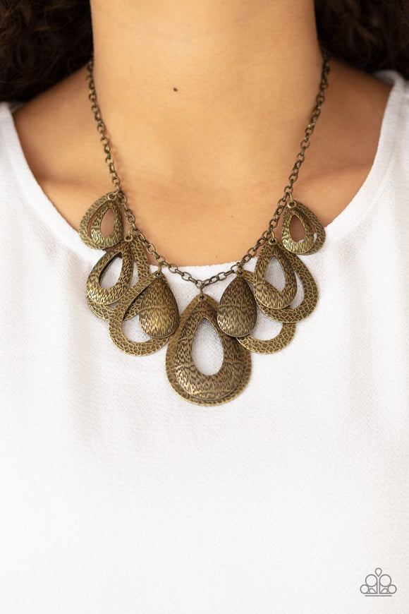 Paparazzi Teardrop Tempest - Brass - Necklace  -  Hammered in an antiqued textured finish, pairs of mismatched brass teardrops gradually increase in size as they drip below the collar, creating a statement-making fringe. Features an adjustable clasp closure.
